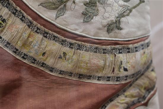 A Chinese embroidered silk and metal thread tunic, perspex case